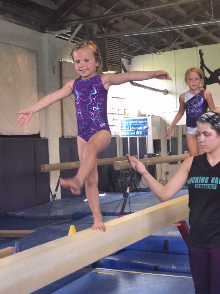 teacher balancing on a beam