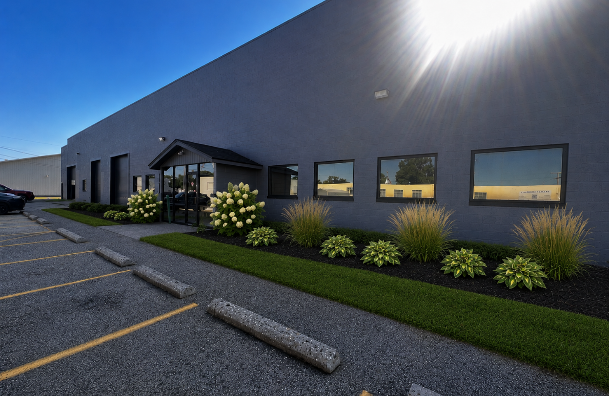 The Hocking Valley Youth Sport Center building at 810 Slocum Street, a gray brick facility with a covered front entrance and landscaped beds along the parking lot