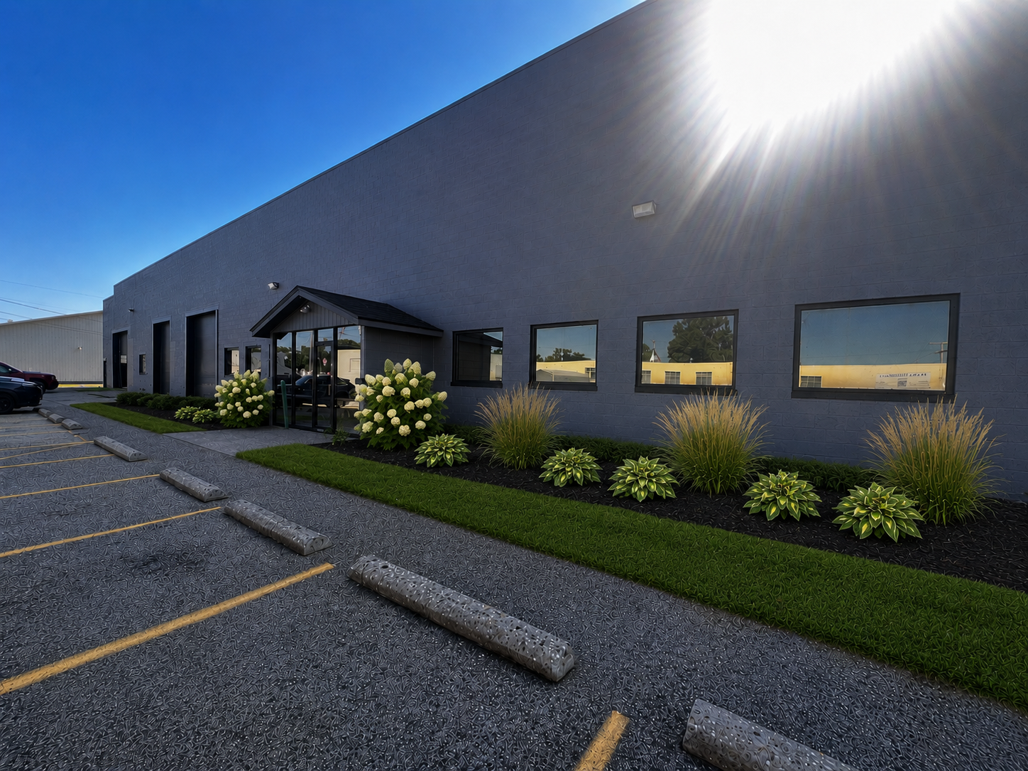The Hocking Valley Youth Sport Center building at 810 Slocum Street, a gray brick facility with a covered front entrance and landscaped beds along the parking lot